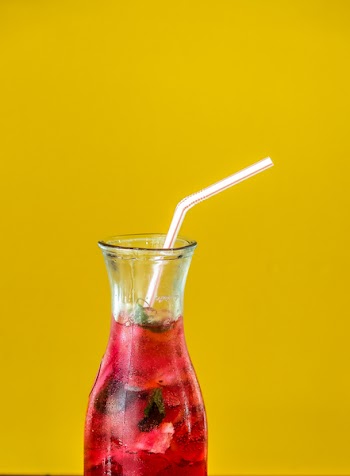 Clear Glass Pitcher and White Straw