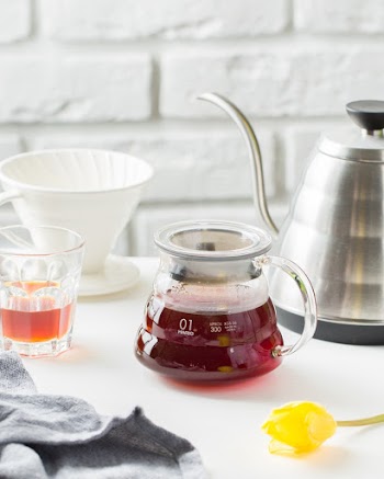 Clear Glass Pitcher Beside Stainless Steel Kettle