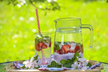 Clear Glass Pitcher With Water and Strawberry