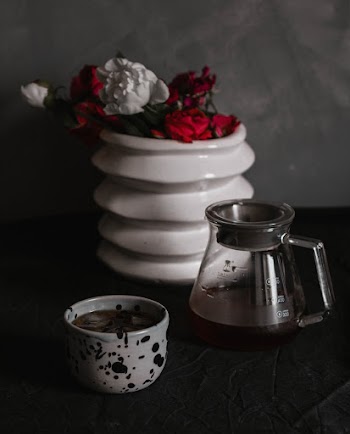 Clear Glass Teapot Beside Cup
