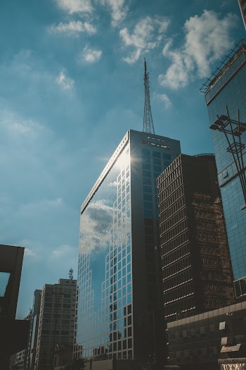 Clear Glass Walled Buildings Under Blue and White Skies