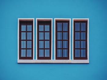 clear glass windows in blue concrete wall