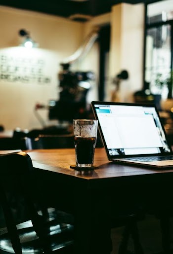 clear highball glass filled with black fluid on tabletop