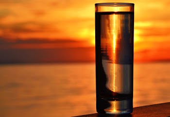 Clear Highball Glass on Brown Surface during Golden Hour