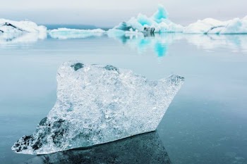 clear iceberg on blue ocean water