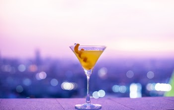 Clear Martini Glass on Purple Surface