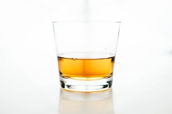 clear rock glass filled with yellow liquid