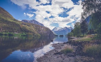Clear Sky over Body of Water and Mountains