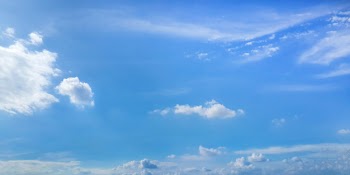 Clear sunny sky with clouds on blue background Free Photo