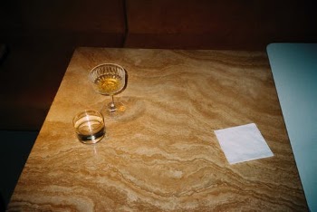 Clear Wine Glass on Brown Floral Textile · Free Stock Photo
