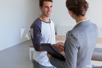 Client shaking hands with realtor in new house