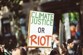 Climate Justice or Riot Banner