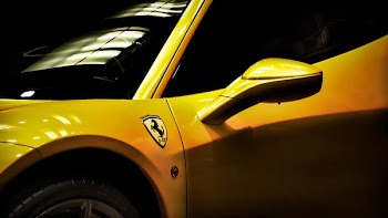 close shot of yellow Ferrari coupe