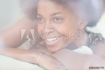 Close up beautiful smiling young woman looking away