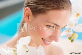 Close up beautiful young woman with orchids