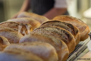 Close up fresh baked bread loaves on rack in bakery