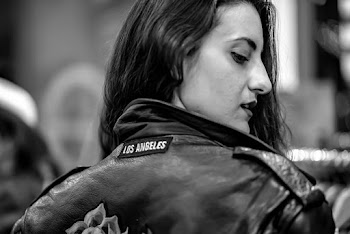 Close-up Grayscale Photo of Woman in Leather Jacket Looking Back