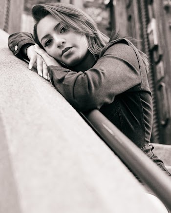 Close-up Grayscale Photo of Woman Leaning on Railing