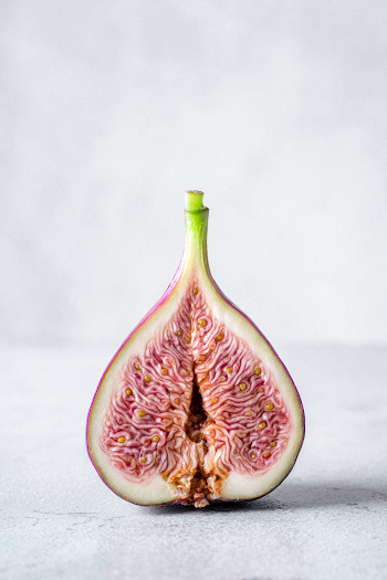 Close-up Halved Fresh Fig on Gray Background