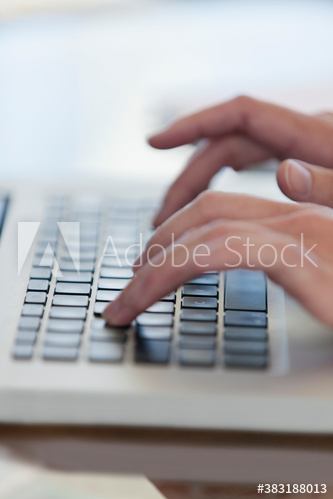 Close up hands typing on laptop