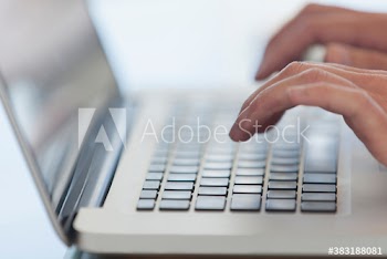 Close up hands typing on laptop