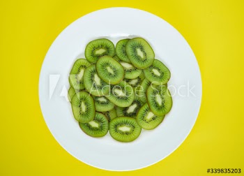 Close up of a plate of green kiwi fruit slices