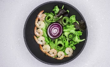 Close-up Of A Steamed Shrimp Salad With Fresh Vegetables In A Metal Bowl