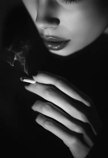 Close-Up of a Woman's Hand Holding a Cigarette in Dark Room