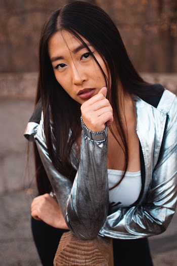 Close-up OF A Woman Wearing Gray Metallic Zip-up Jacket