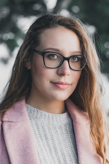 Close-up Of A Women Wearing Black Framed Eyeglasses