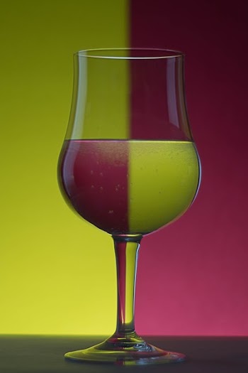 Close-up of Beer Glass Against Colored Background