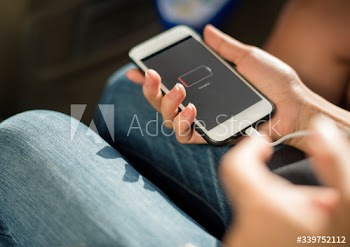 Close up of hands charging mobile phone