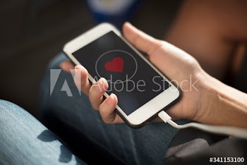 Close up of hands charging mobile phone