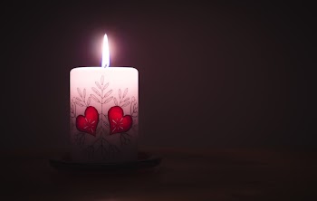 Close-up of Illuminated Candle Against Black Background