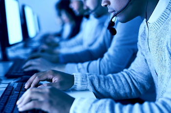 Close-Up of Office Workers in Tech Support Environment
