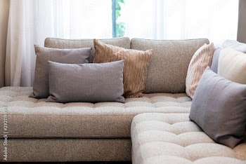 close up of soft fabric pillow decoration on beautiful sofa in living room home design concept