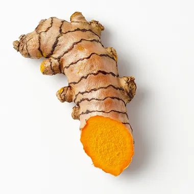 Close-up of turmeric root on white background, bright summer lighting Close-up of turmeric root on white background, bright summer lighting