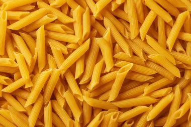 Close-Up of Uncooked Yellow Penne Pasta Close-Up of Uncooked Yellow Penne Pasta