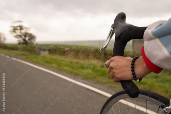 Close-up of woman cycling on rural road