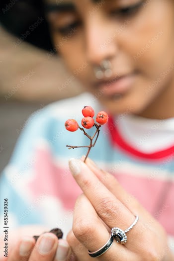Close-up of woman holding rowanberry