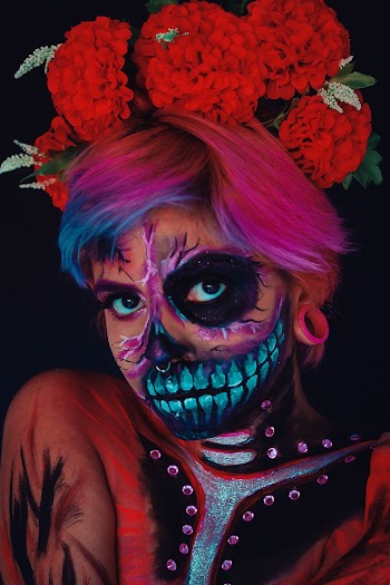Close-up Of Woman With Face Painting and Red Flower Headdress
