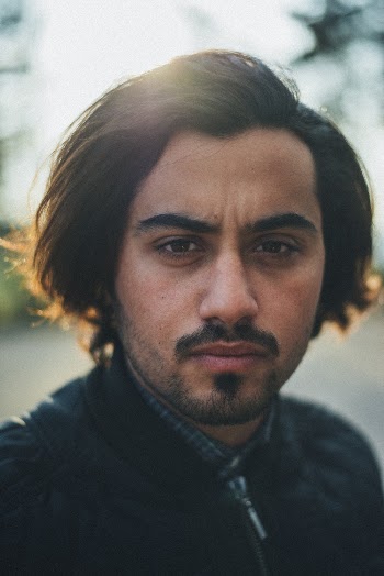 Close-Up Photo of a Man Wearing Black Top