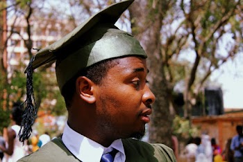 Close-Up Photo of a Man Wearing Green Academic Dress