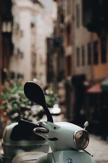 Close-up Photo of a Parked White Motor Scooter
