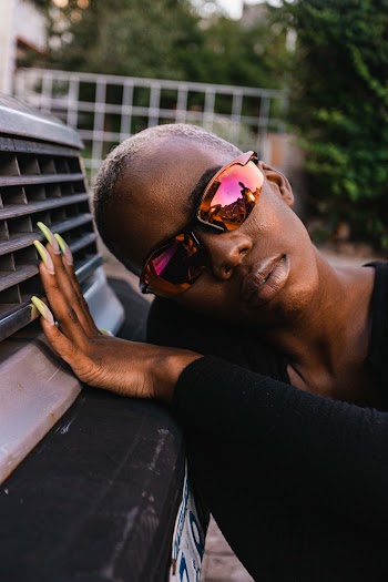 Close-up Photo of a Person Leaning on Car