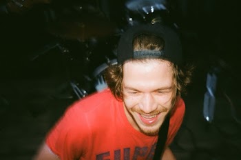 Close-Up Photo of a Smiling Man in Red Shirt