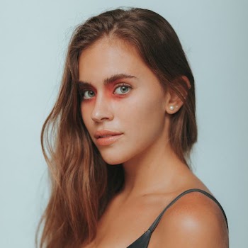 close-up photo of a woman posing while wearing black spaghetti strap top