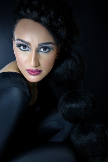 Close-up photo of a woman wearing black full body suit  