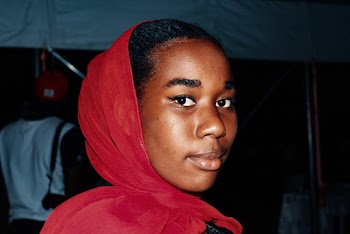 Close-Up Photo of a Woman Wearing Red Scarf