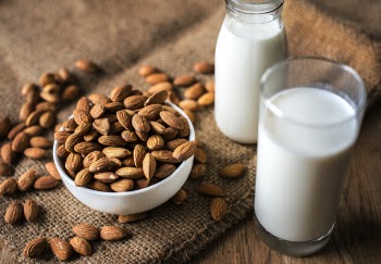 Close-Up Photo of Almonds Near Milk